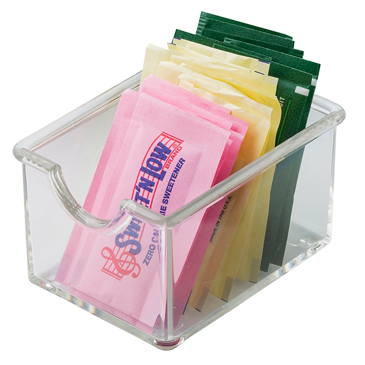 A clear acrylic Sugar Packet Holder by TableCraft holds assorted sweetener packets—pink, yellow, and green—neatly upright and separated by color. The container is dishwasher safe and has a front cutout for easy access.