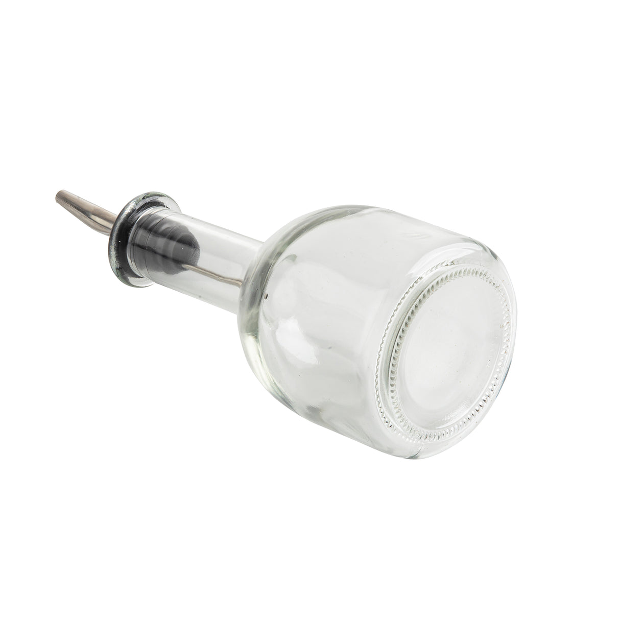 A clear glass oil & vinegar bottle lies on its side with a stainless steel pourer inserted into its neck. The plain white background highlights the bottle’s transparency and the reflective metal of the pourer. Capacity: 10 oz.