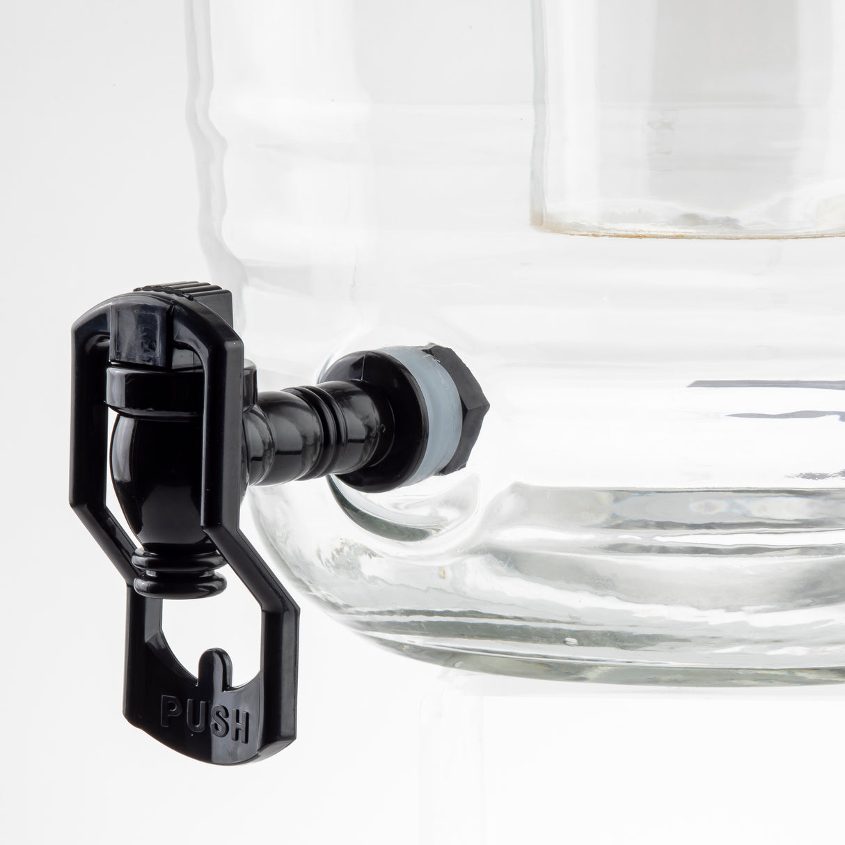 Close-up of a clear glass beverage dispenser with a black plastic spigot, similar to some Universal Touchless Faucet designs, featuring a lever labeled PUSH. Set against a plain white background, the dispenser stands out prominently.