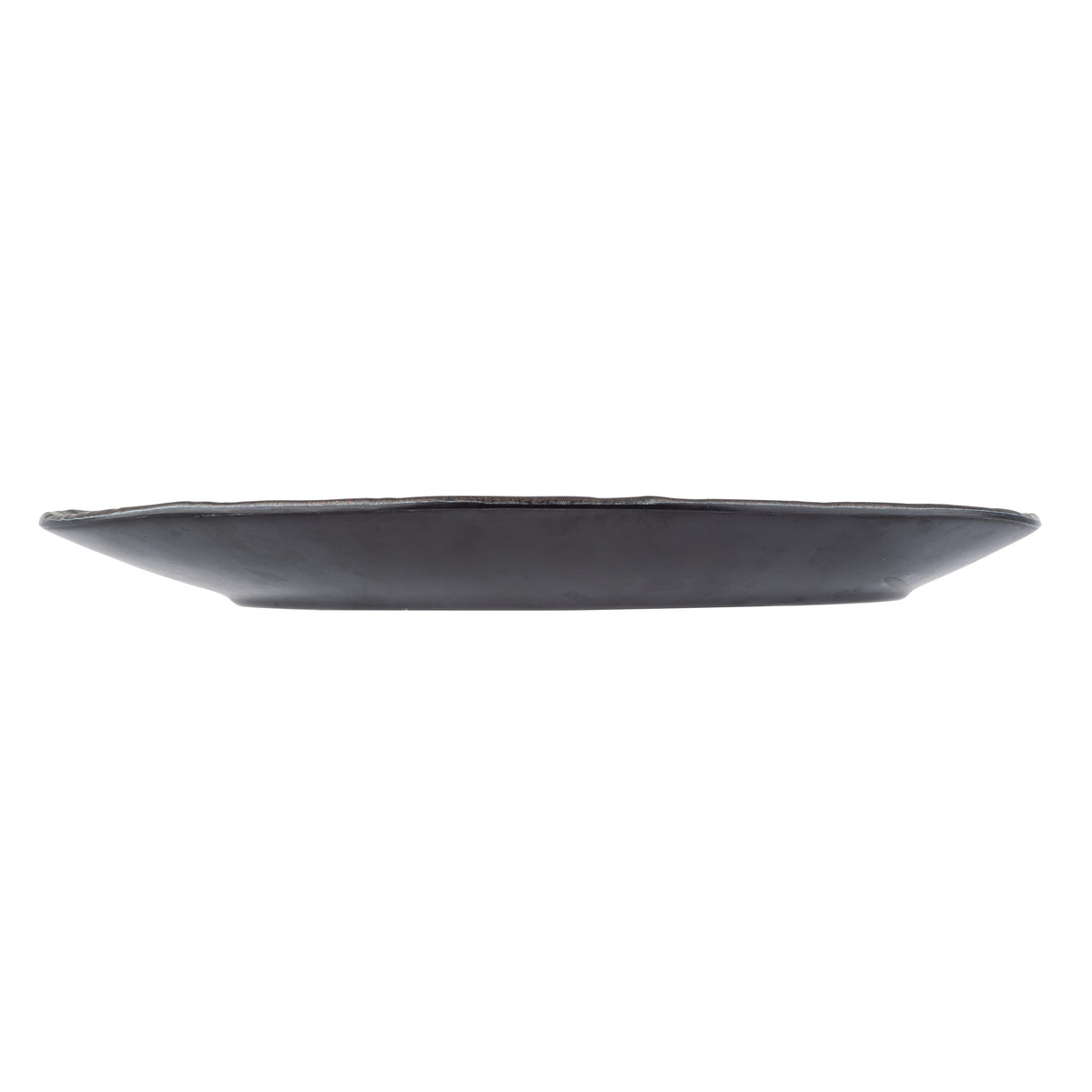 A low, round Lunara Collection Plate in black ceramic is seen from the side against a white background; the plate features a slightly irregular, handcrafted edge and a flat, gently sloping profile.