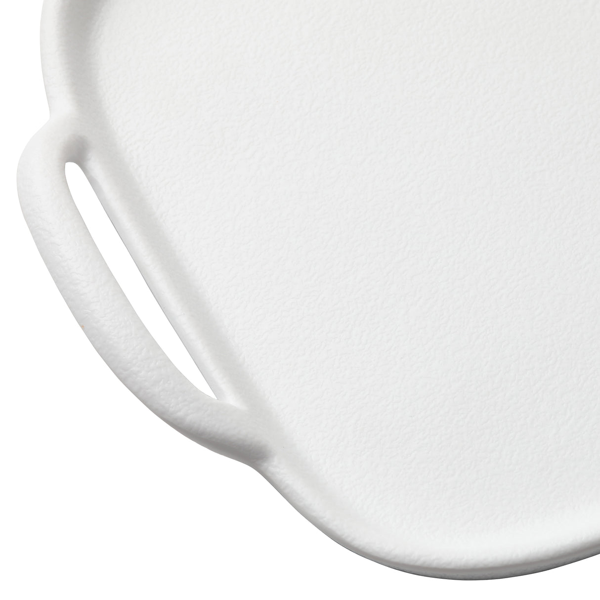Close-up of a white melamine serving tray with a textured surface. The image shows one corner, featuring a rounded edge and an integrated handle with an oval cutout, set against a plain white background. Dishwasher safe for easy cleaning.