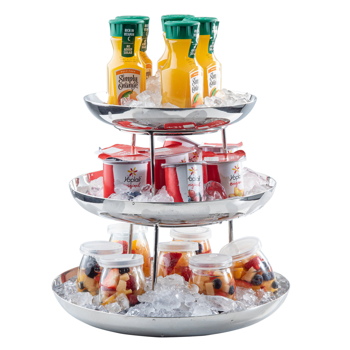 A 3-tier stainless steel stand, reminiscent of a Seafood Tower, holds bottles of orange juice on top, Yoplait yogurt cups in the middle, and jars of fruit salad on ice at the bottom, all set against a crisp white background.