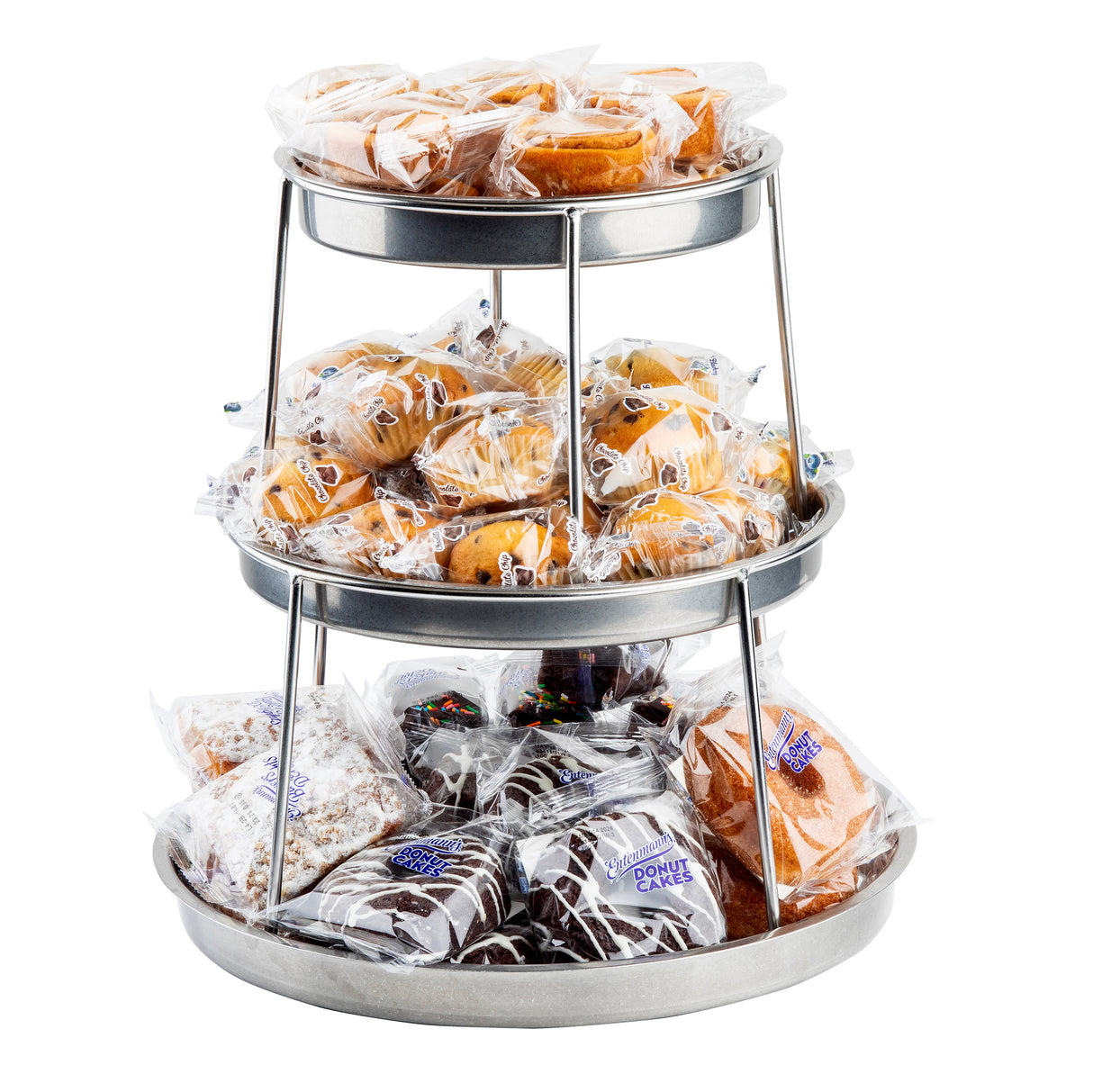 A 3-tier stainless steel sharing tower displays individually wrapped baked goods—donuts, muffins, and pastries. Each treat is neatly arranged in clear plastic packaging, making a tempting selection of snack cakes and sweets easily visible.