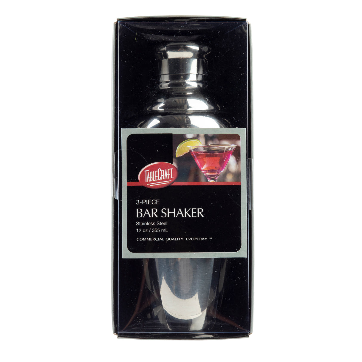 A stainless steel 12 oz TableCraft bar shaker, part of a sleek bar shaker set, is packaged in a black box with a clear front. The label features an image of a pink cocktail with lemon garnish and reads “3-piece Bar Shaker, Stainless Steel, 12 oz / 355 ml.”.