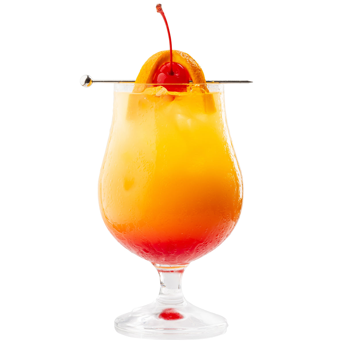 A hurricane glass filled with a vibrant layered cocktail, featuring a red-to-yellow gradient. The drink is garnished with an orange slice and cherry, skewered by a TableCraft stainless steel cocktail pick, against a white background.