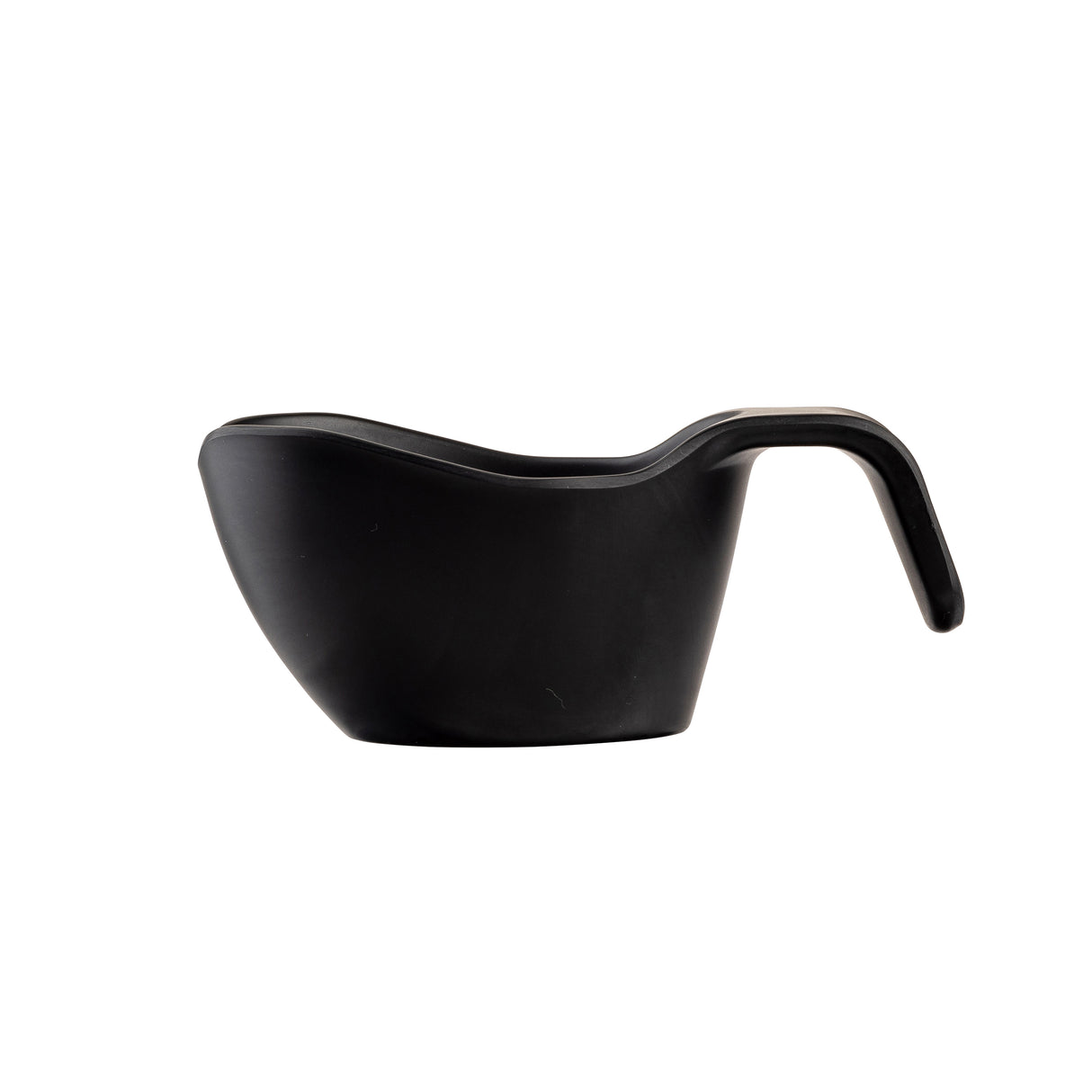 A matte black melamine sauce boat with a modern, curved shape and an ergonomic handle, photographed on a white background. The wide spout and stackable design add to its sleek, minimalist appeal.