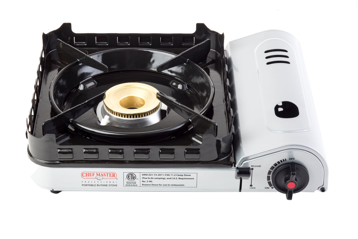 A portable Butane Stove with a black metal grate, brass burner, and gray body. The control knob on the right allows for ignition and flame adjustment. A product label is visible on the front of this 8,000 BTU device.