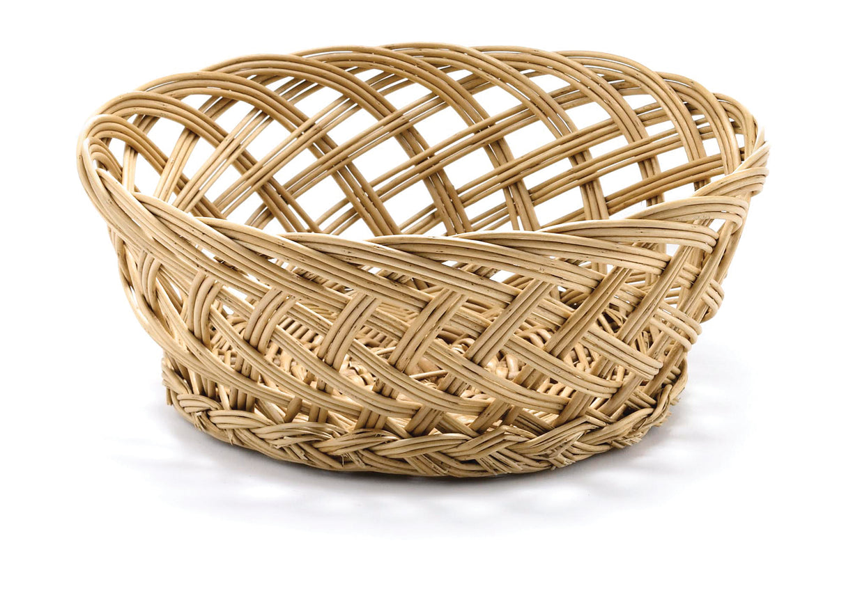 A round, empty, light-brown handwoven basket with an open weave pattern sits on a white surface. The basket features intertwined, crisscrossed strands and a slightly flared rim, creating a textured, airy appearance.