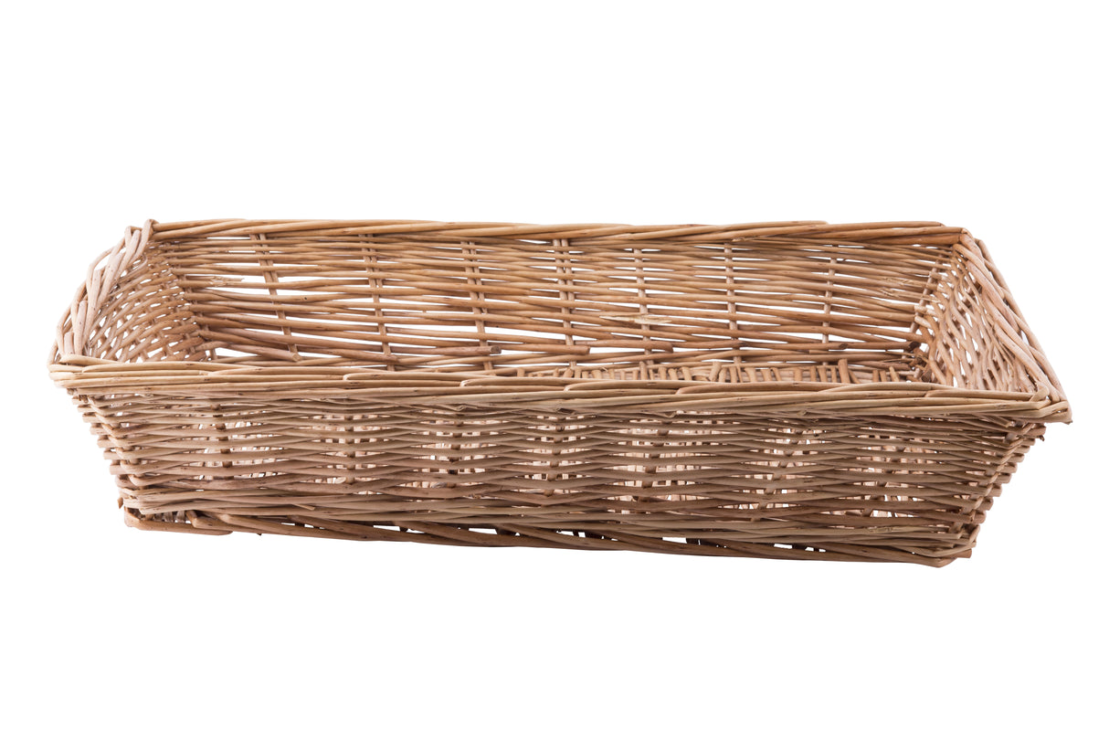 A rectangular handwoven basket with an open top, crafted from light brown reeds. The basket features slightly slanted sides and a flat base, with visible gaps between the woven strands. It is empty and sits on a white background.