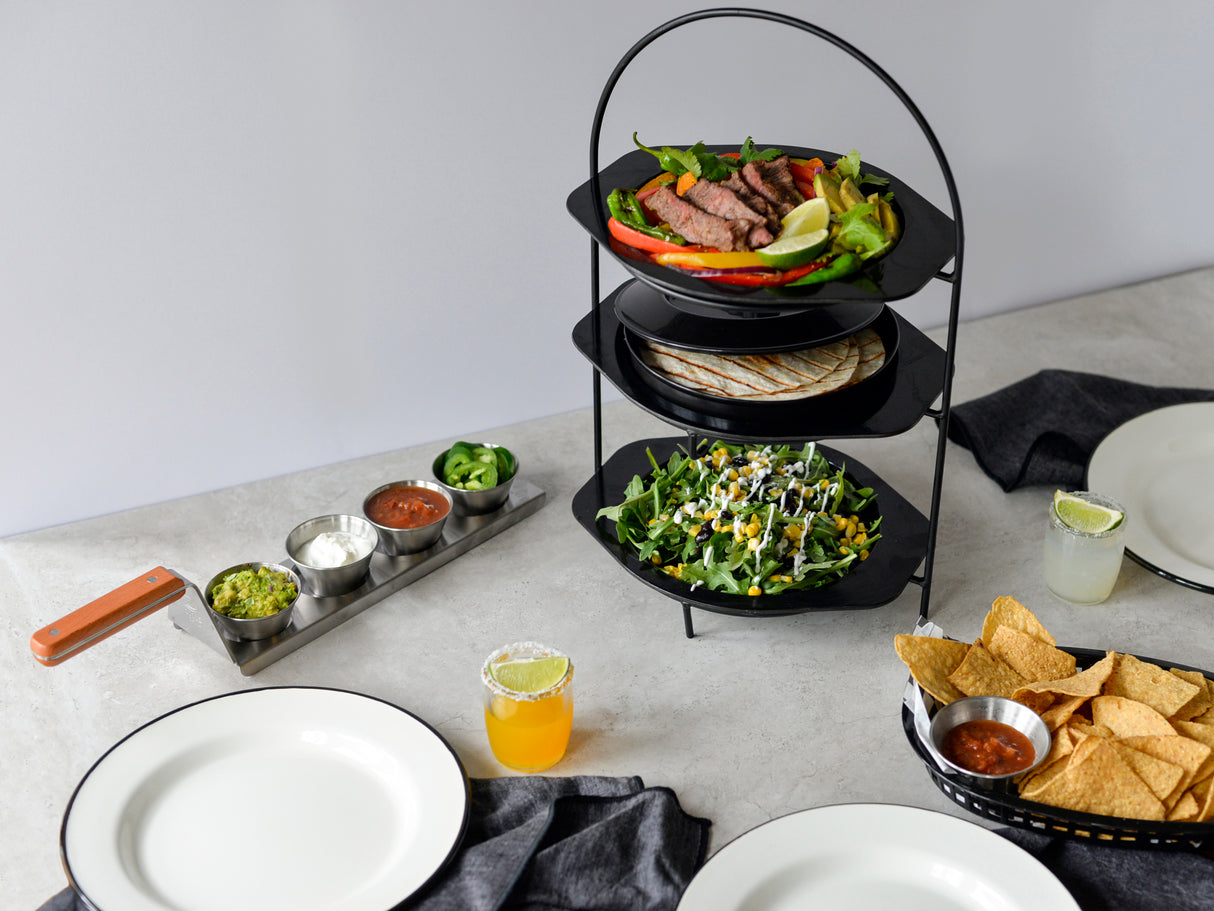 A delicious plate of food served on a stainless steel plate sits atop the table, adding a touch of modern elegance.