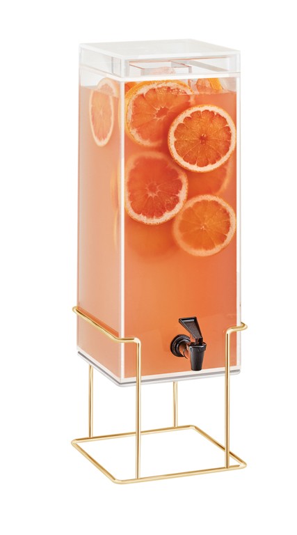A tall, clear 3 gallon beverage dispenser with a black spigot, filled with a pink-orange drink and orange slices. It stands on a gold metal frame and features a transparent lid on top for stylish mid-century appeal.