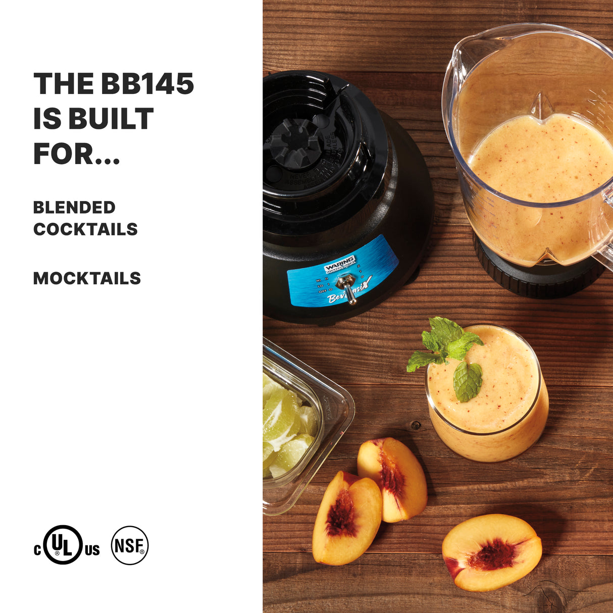A Bar Blender with a 48 oz. capacity blends a peach-colored smoothie on a wood surface, next to its lid, a glass of the smoothie garnished with mint, peach slices, and lime wedges. Text reads: THE BB145 IS BUILT FOR... BLENDED COCKTAILS MOCKTAILS.