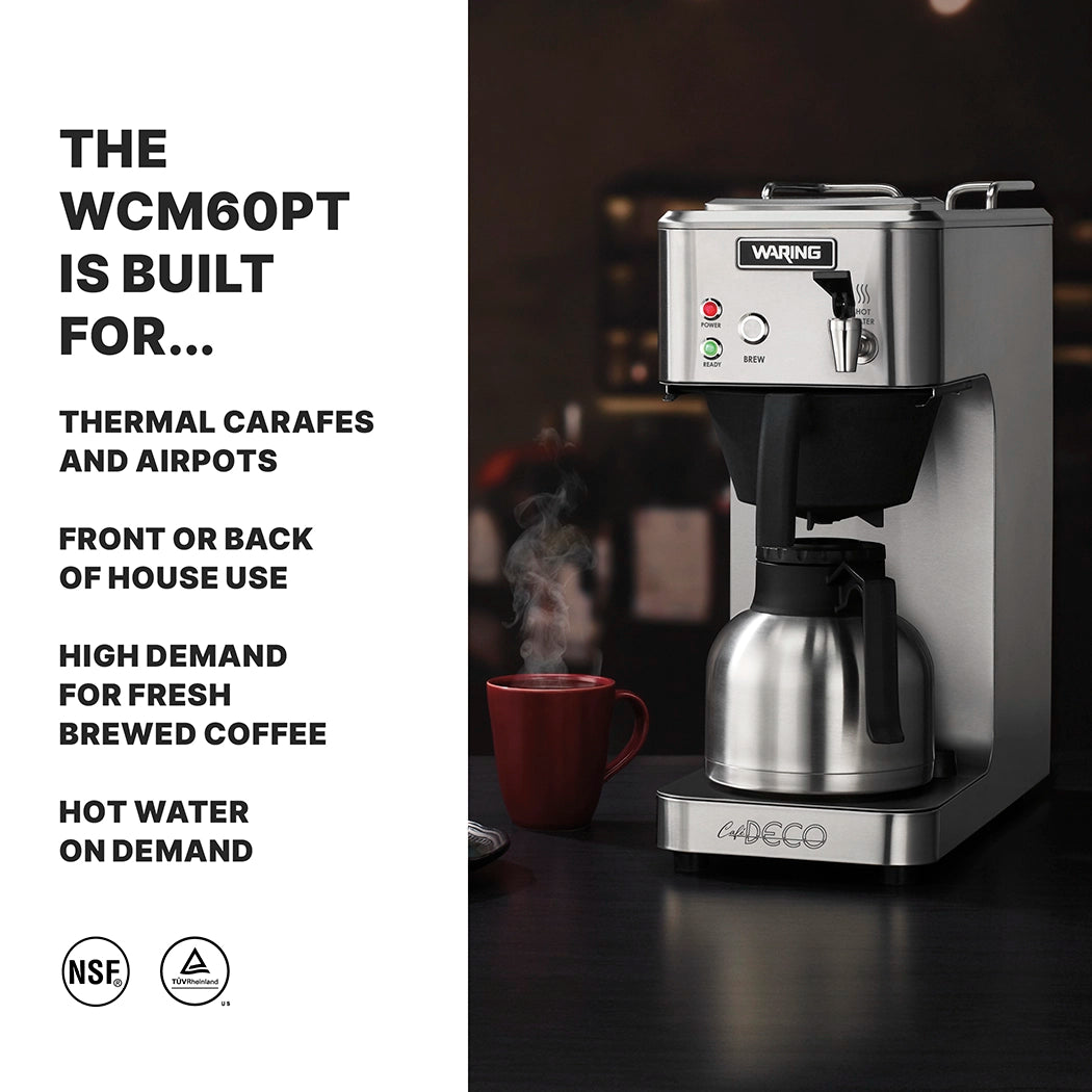 A thermal coffee brewer sits on a dark counter, brewing coffee into a metal carafe. A red mug, silver spoon, and steaming cup evoke café deco vibes. Bold text highlights this commercial coffee maker’s hot water on demand and fresh brewed features.