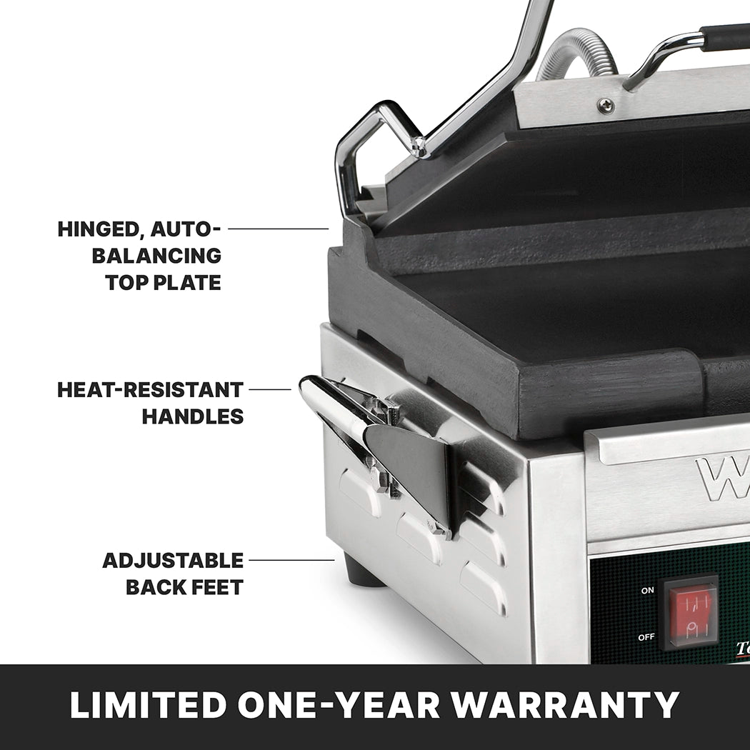 Close-up of a compact toasting grill panini press with labeled features: Hinged, auto-balancing top plate, heat-resistant handles, adjustable back feet, and a digital display. A banner reads LIMITED ONE-YEAR WARRANTY.