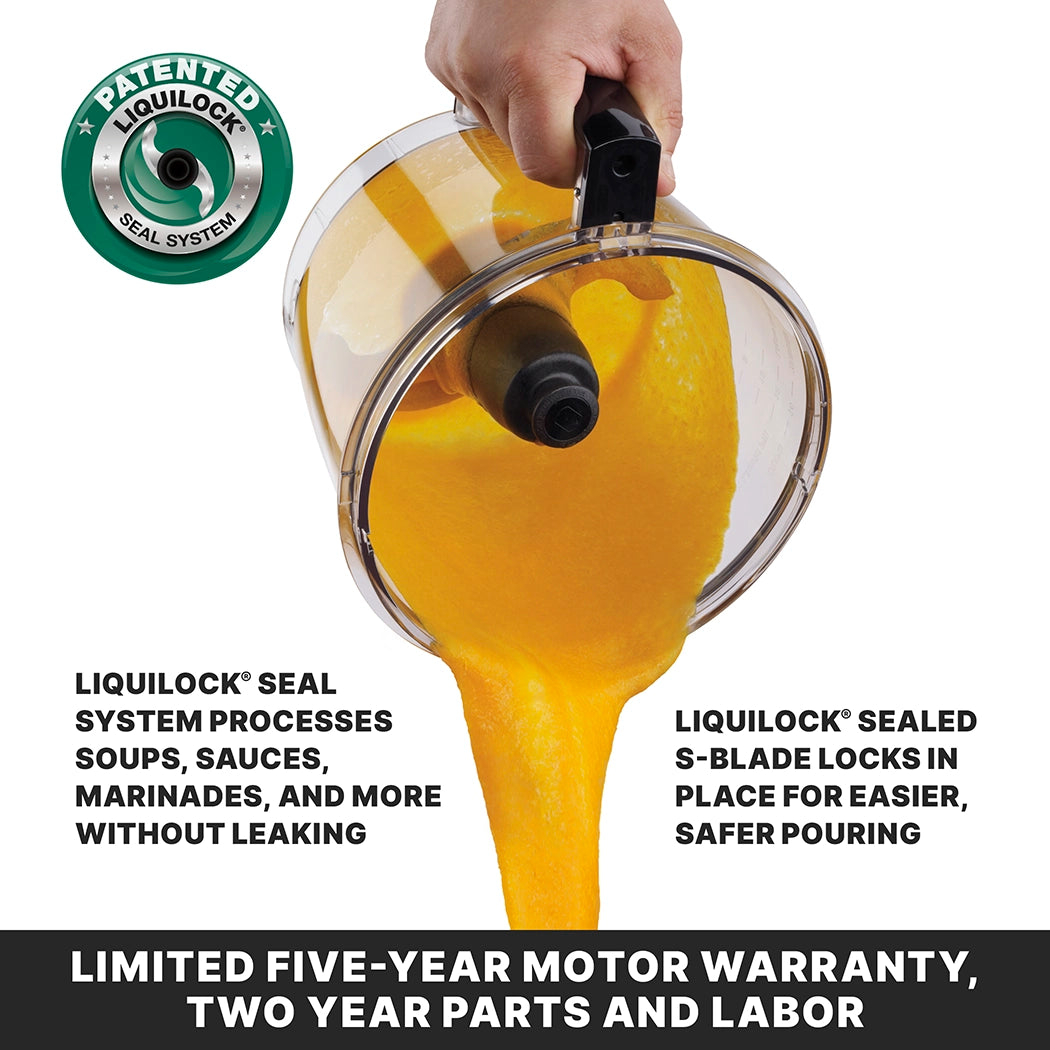 A hand pours thick orange soup from a 4 qt batch bowl food processor with an S-blade. Text highlights the LiquiLock seal system, which prevents leaks and locks the blade for safe pouring. Warranty info is listed below.