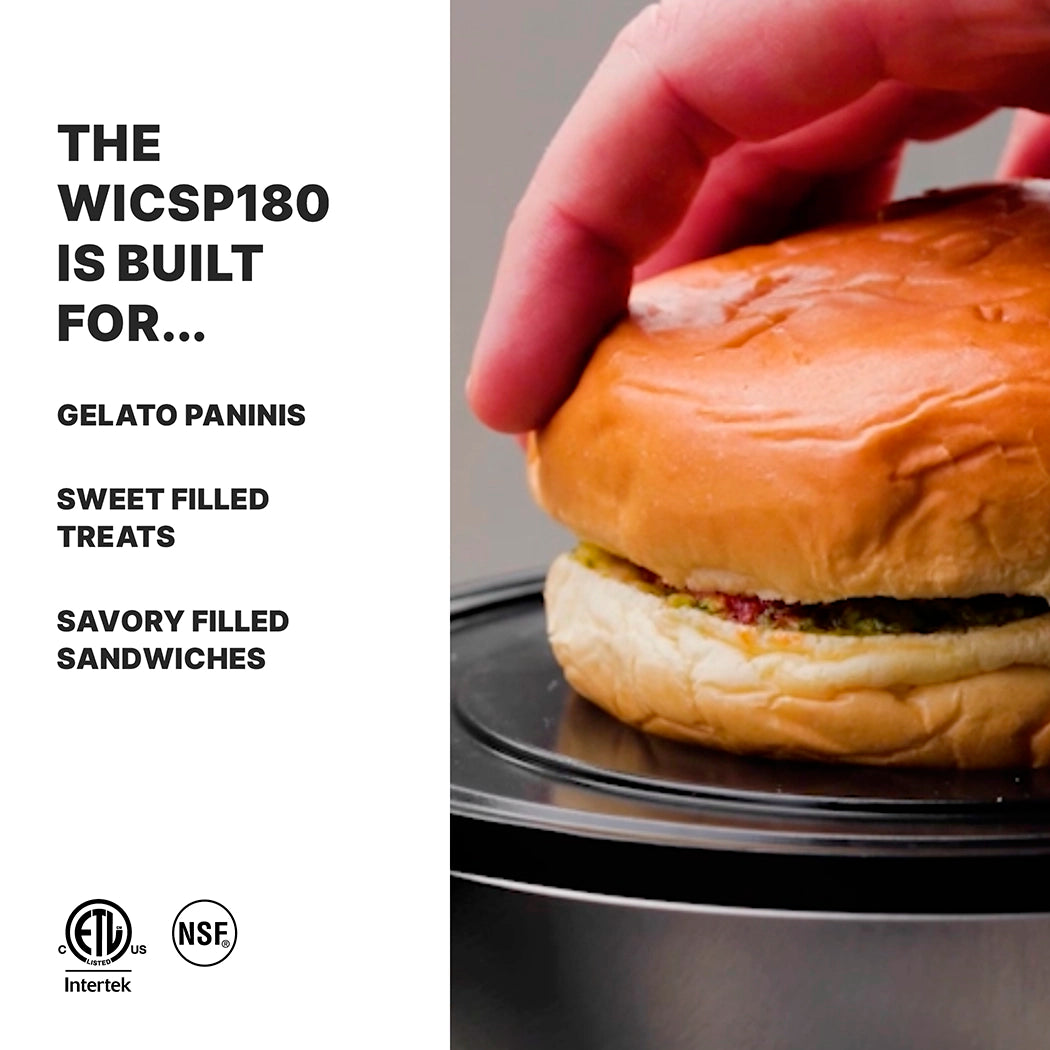 A close-up of a hand pressing down on a sandwich bun filled with green and brown ingredients on a black plate. Left side text reads: The WICSP180 Gelato Panini Press is built for gelato paninis, sweet treats, and savory sandwiches, with certification logos below.
