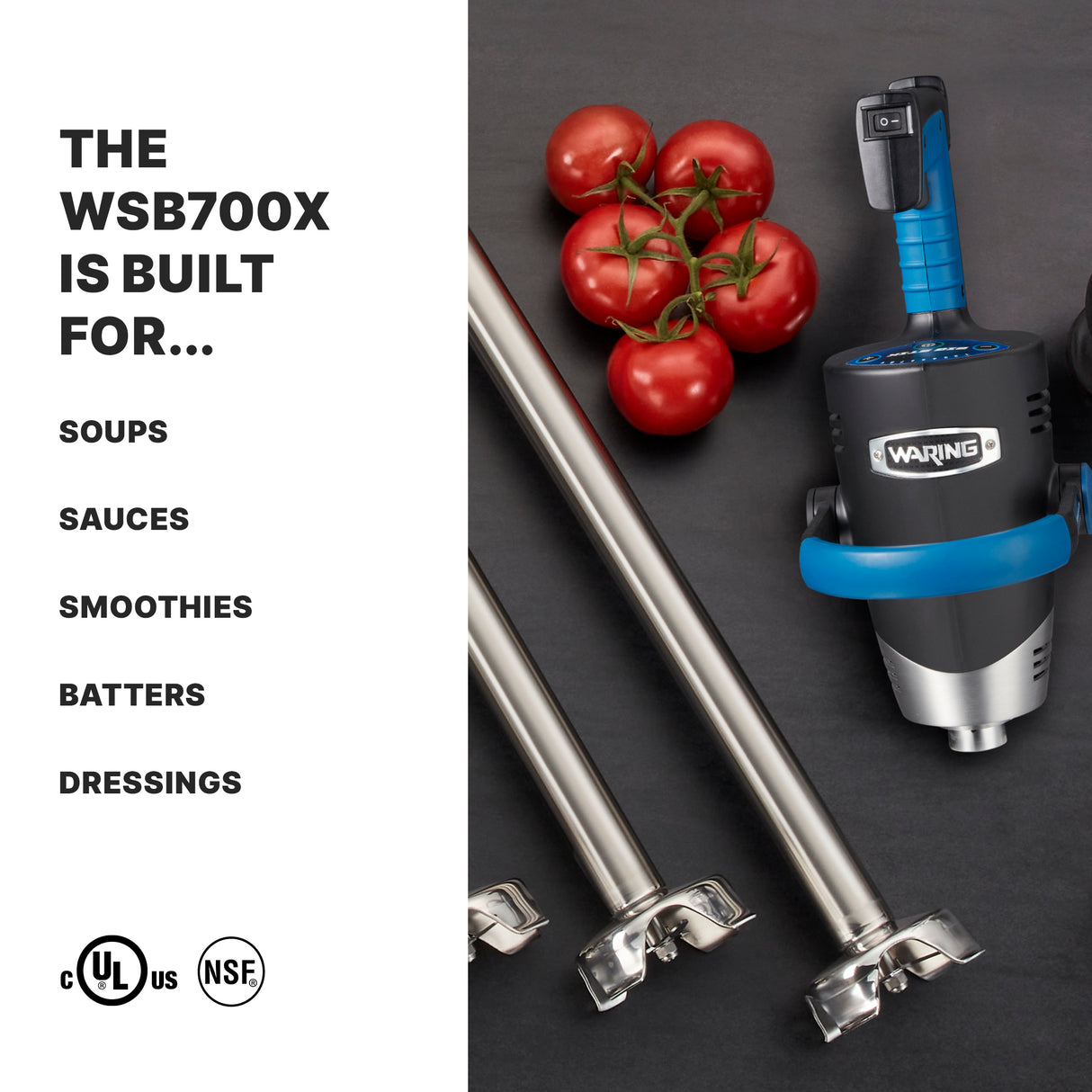 A heavy duty Waring immersion blender with blue accents lies on a dark surface next to four stainless steel blender shafts and a cluster of red tomatoes. Text on the left reads: “The WSB700X is built for… soups, sauces, smoothies, batters, dressings.”.