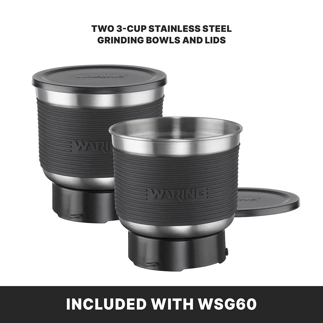 Two 3-cup stainless steel grinding bowls with lids are shown, designed for the Waring WSG60K commercial spice grinder. Both bowls feature black bases and ribbed exteriors. Text above reads “TWO 3-CUP STAINLESS STEEL GRINDING BOWLS AND LIDS.”.