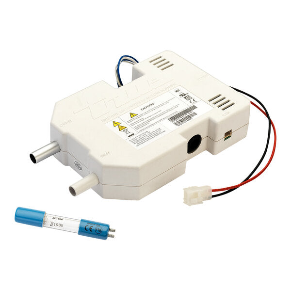 A white UV-C lamp ballast with ventilation slots, warning labels, and two metal output ports is shown. A blue UV-C lamp and a white connector with red and black wires are placed beside the ballast, ideal for bacteria inhibitor use in ice makers.