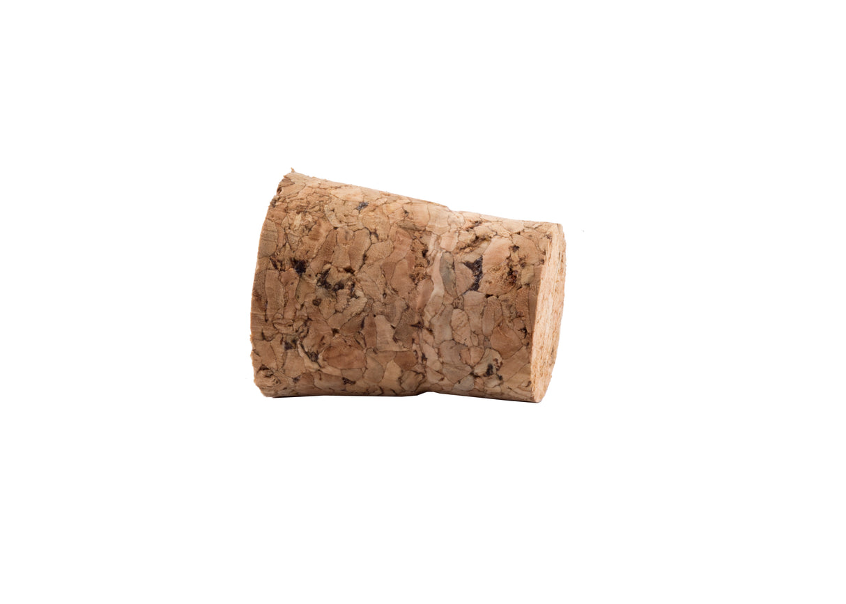 A cylindrical TableCraft cork stopper made of natural cork material lies on its side against a white background. The cork has a rough, textured surface with visible grain and small cracks and is hand wash only.