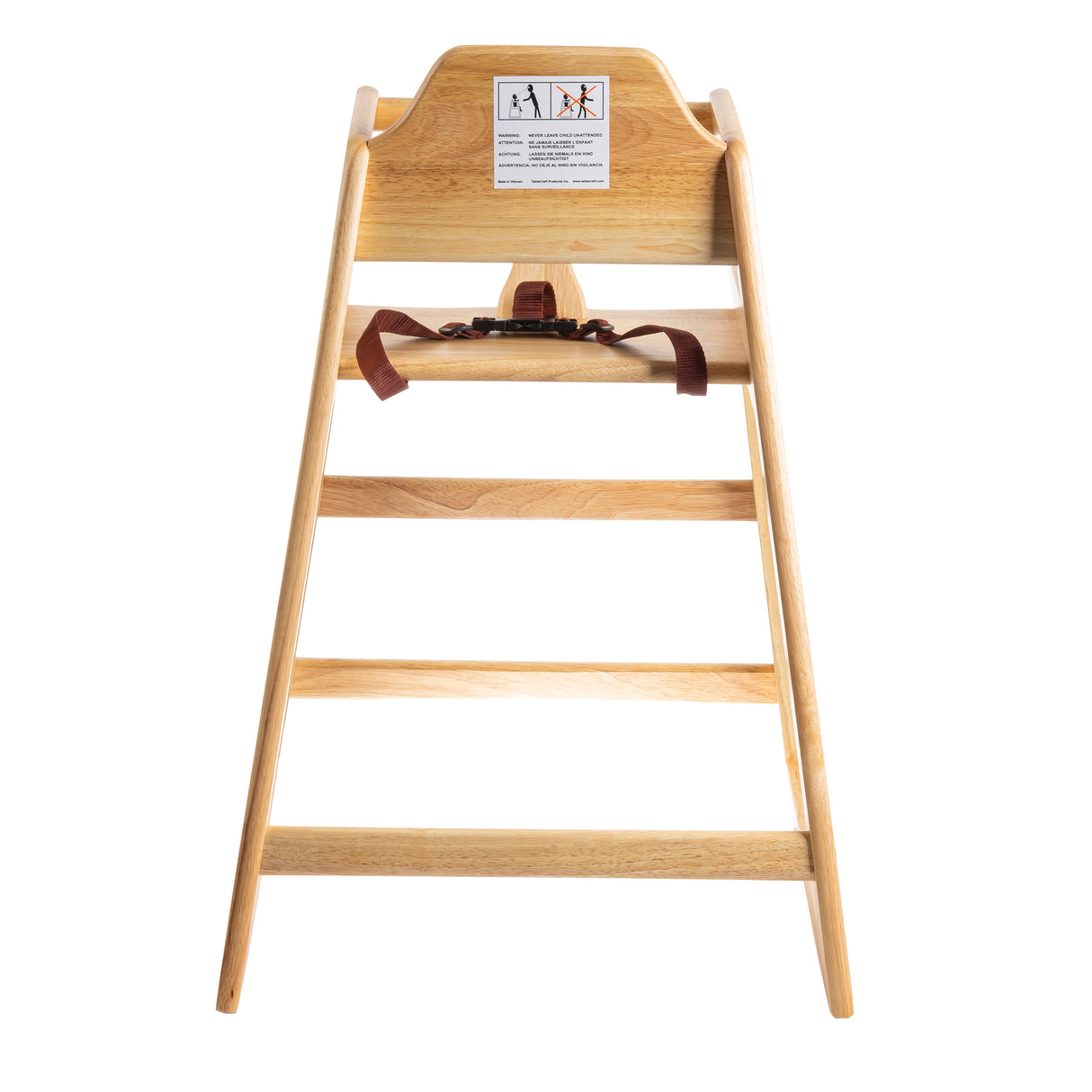 A stackable wooden high chair with a safety harness is shown from the front. The chair has a natural wood finish and features an ASTM F404-18 compliant warning label with safety instructions on the upper backrest, against a white background.