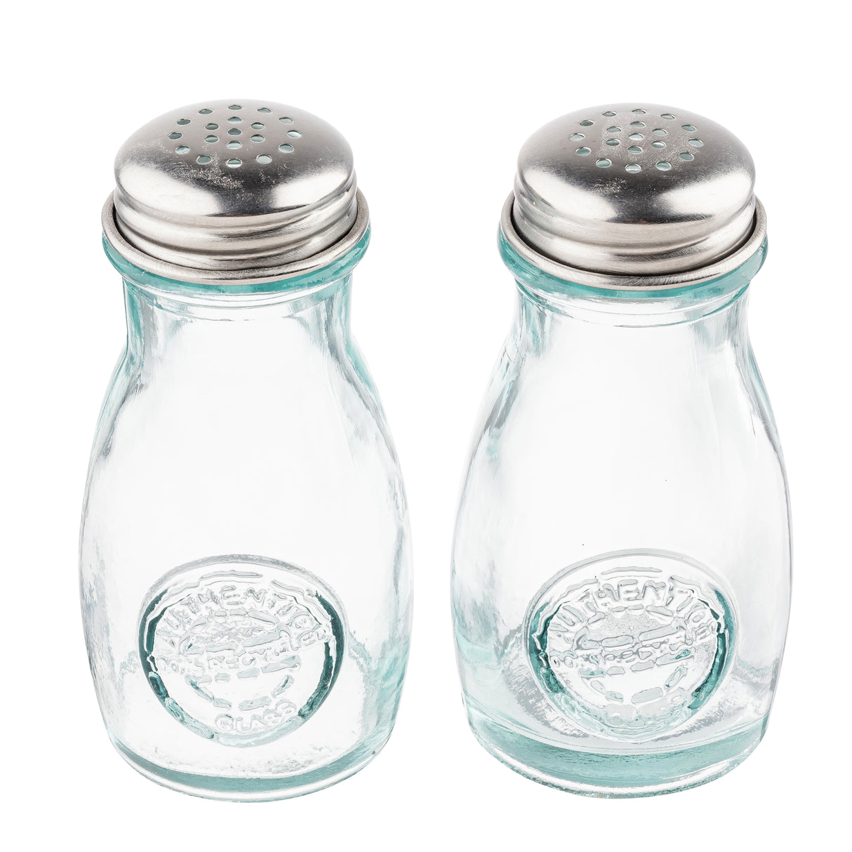 Two empty, clear recycled glass jars with round bodies and stainless steel tops stand side by side on a white background. Each shaker has an embossed circular logo on the front, making this shaker set both stylish and eco-friendly.