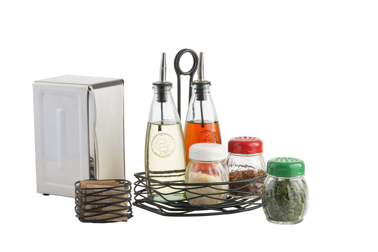 Part of the Artisan Collection, this condiment set features black powder coated metal details and includes a sugar packet holder, two glass bottles with metal tops, three spice jars, napkin holders with brown and white napkins—all on a wire rack.