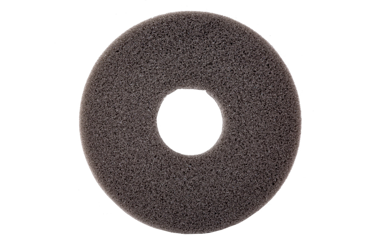 A dark gray, circular foam pad with a coarse texture, photographed on a white background. This replacement sponge features a large central hole, resembling a donut or ring shape. The lighting highlights its porous surface details.