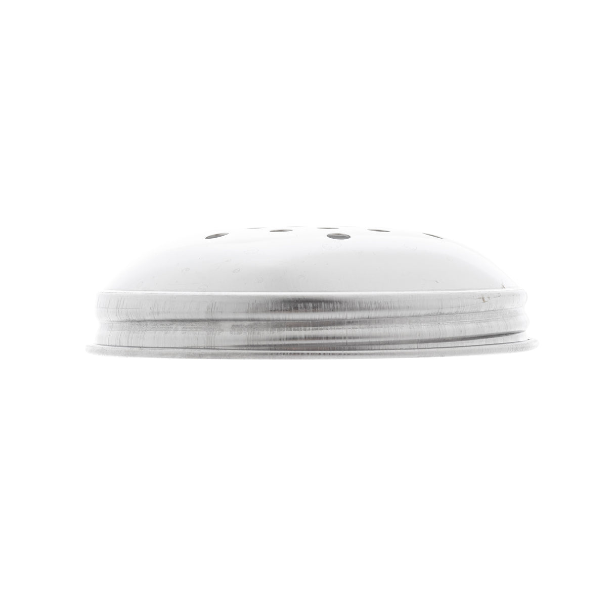 A close-up side view of a metallic, dome-shaped lid with a perforated top, featuring several small holes, isolated on a white background. The object appears to be the lid of a salt or pepper shaker.