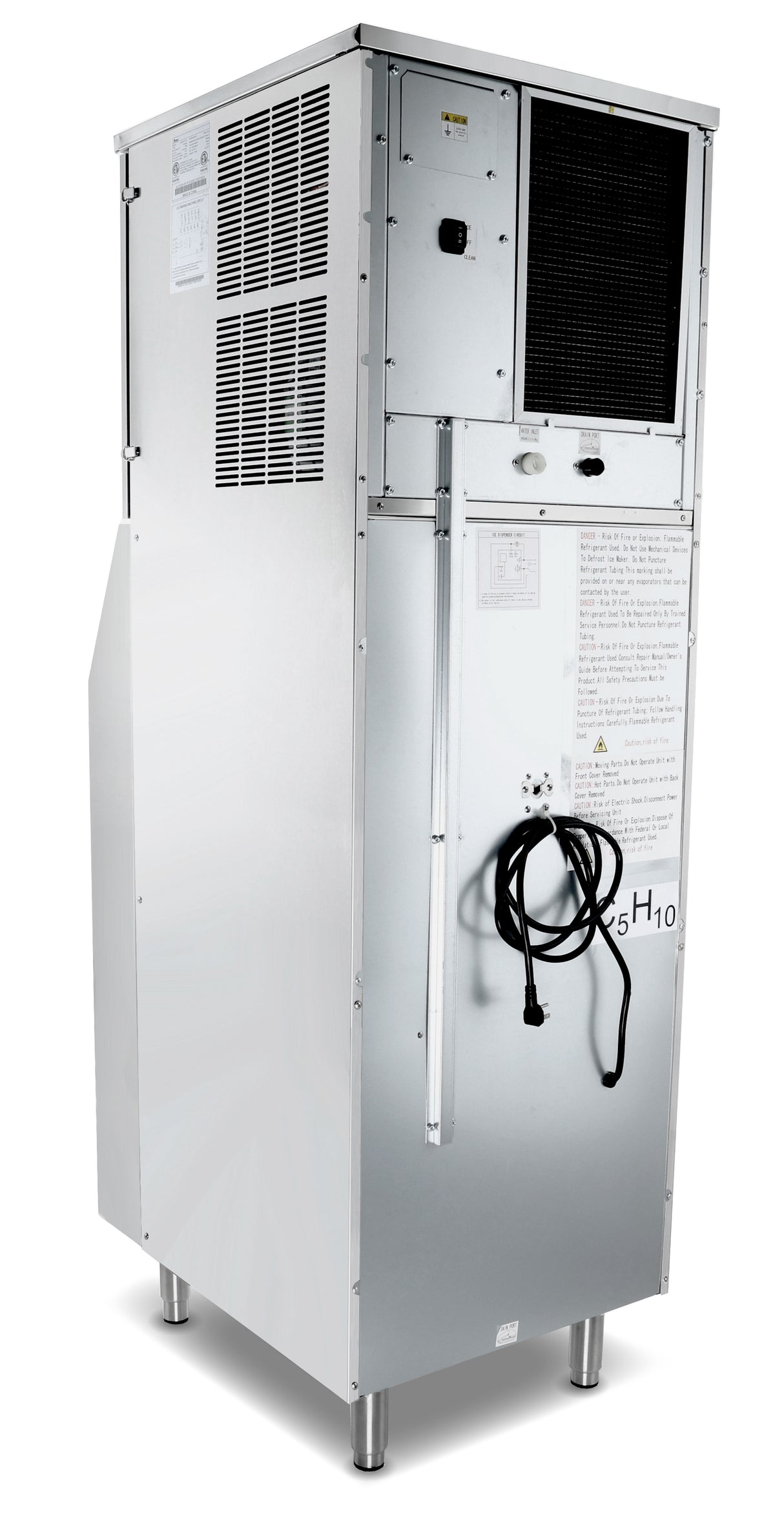A large, silver, rectangular hotel ice machine with vent panels, a control panel, and a black cord hanging on the front stands on four metal legs. Labels, warning signs, and various screws and panels mark this full cube ice dispensers surface.