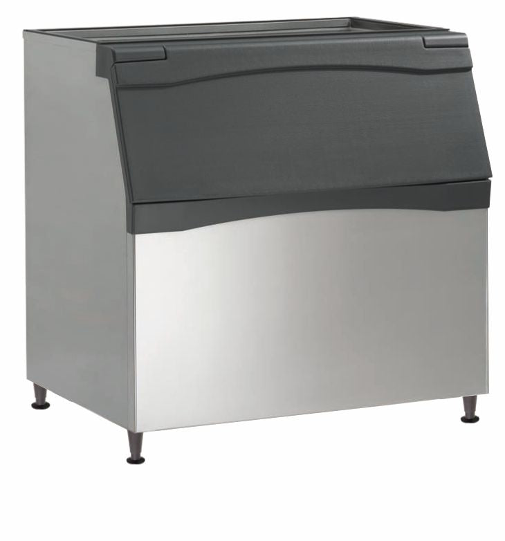 A large commercial ice bin with 893 lb capacity features a stainless steel body, black plastic curved lid, and four short metal legs. The slanted front with a hinged lid offers easy access to stored ice and is ideal for use with a top-mounted ice maker.