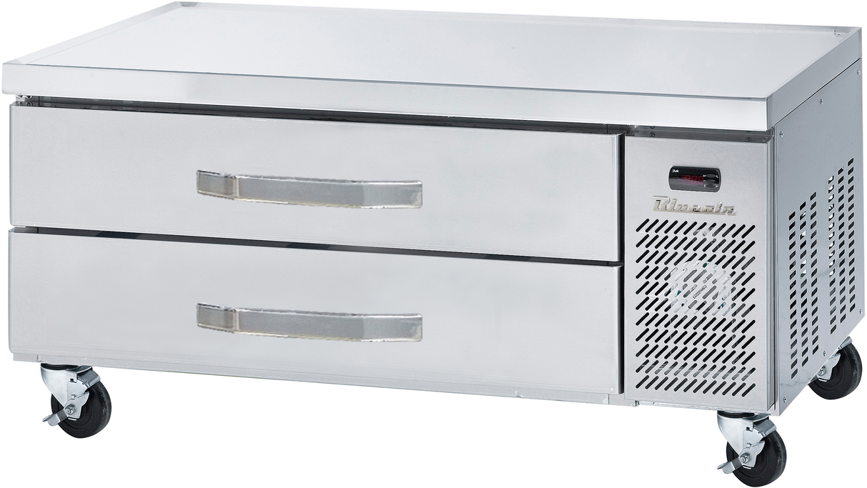 A commercial stainless steel Refrigerated chef base with two pull-out drawers and a vented section on the right, fitted with four caster wheels for mobility. The brand name “Thorin” is visible above the vent.