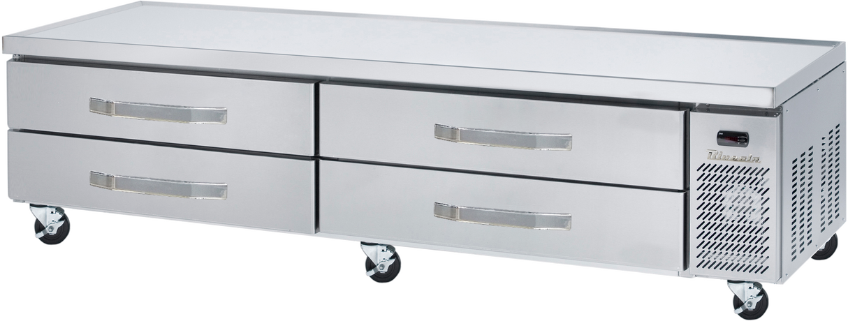A stainless steel refrigerated chef base with four horizontal drawers, mounted on caster wheels. The right end features a vented panel and control display. The flat top surface serves as an ideal equipment stand for food prep in a professional kitchen.