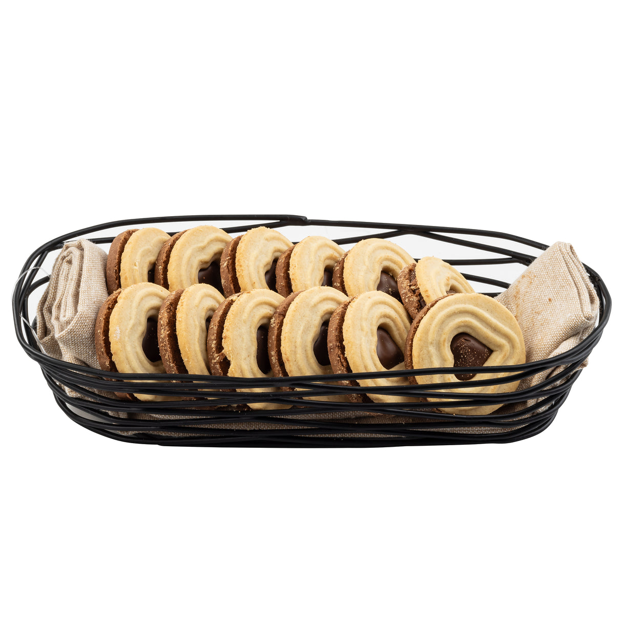 A black powder coated metal basket lined with beige cloth holds two neat rows of sandwich cookies filled with chocolate and topped with a shiny beige glaze, all arranged on a white background.