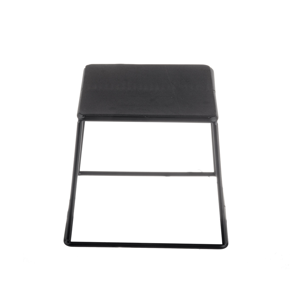 A black, minimalist folding stool with a square seat and thin black powder coated metal legs is shown against a white background, viewed directly from above. The stool has a simple, modern design reminiscent of a TableCraft Products riser set.