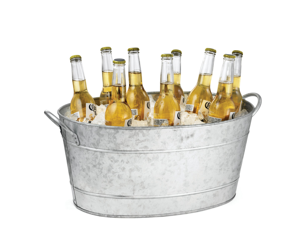 A TableCraft galvanized steel beverage tub filled with ice holds eleven clear glass bottles of light beer with yellow labels and caps. The tub features two side handles and sits against a plain white background.