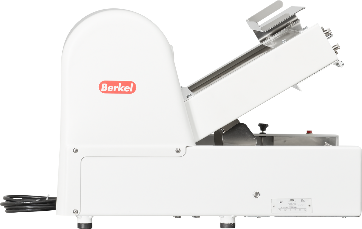 A side view of a white Berkel meat slicer with a power cord, angled tray, and blade guard. The red Berkel logo is visible on the machine’s left side. This countertop bread slicer sits on small feet, designed for commercial kitchen use.