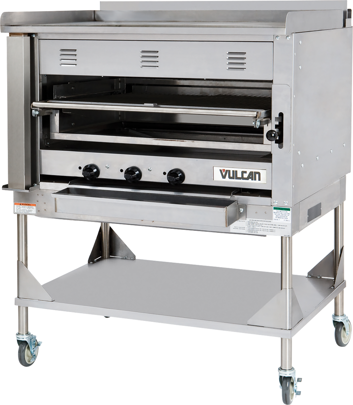 A large commercial stainless steel oven with three control knobs, vented front, and a pull-down door features the Vulcan logo. This Heavy Duty Chophouse Broiler sits on a metal stand with a lower shelf and four caster wheels for mobility.
