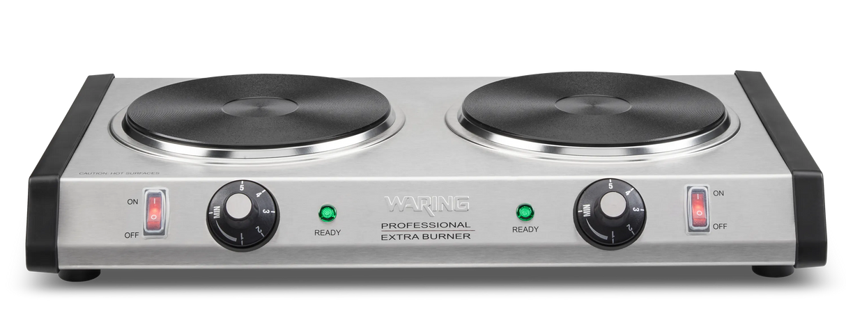 A heavy-duty stainless steel double-burner electric hot plate features two black cast iron burner plates, control knobs, and separate power switches. Each burner has a "Ready" indicator light. The front reads Waring Professional Extra Burner.