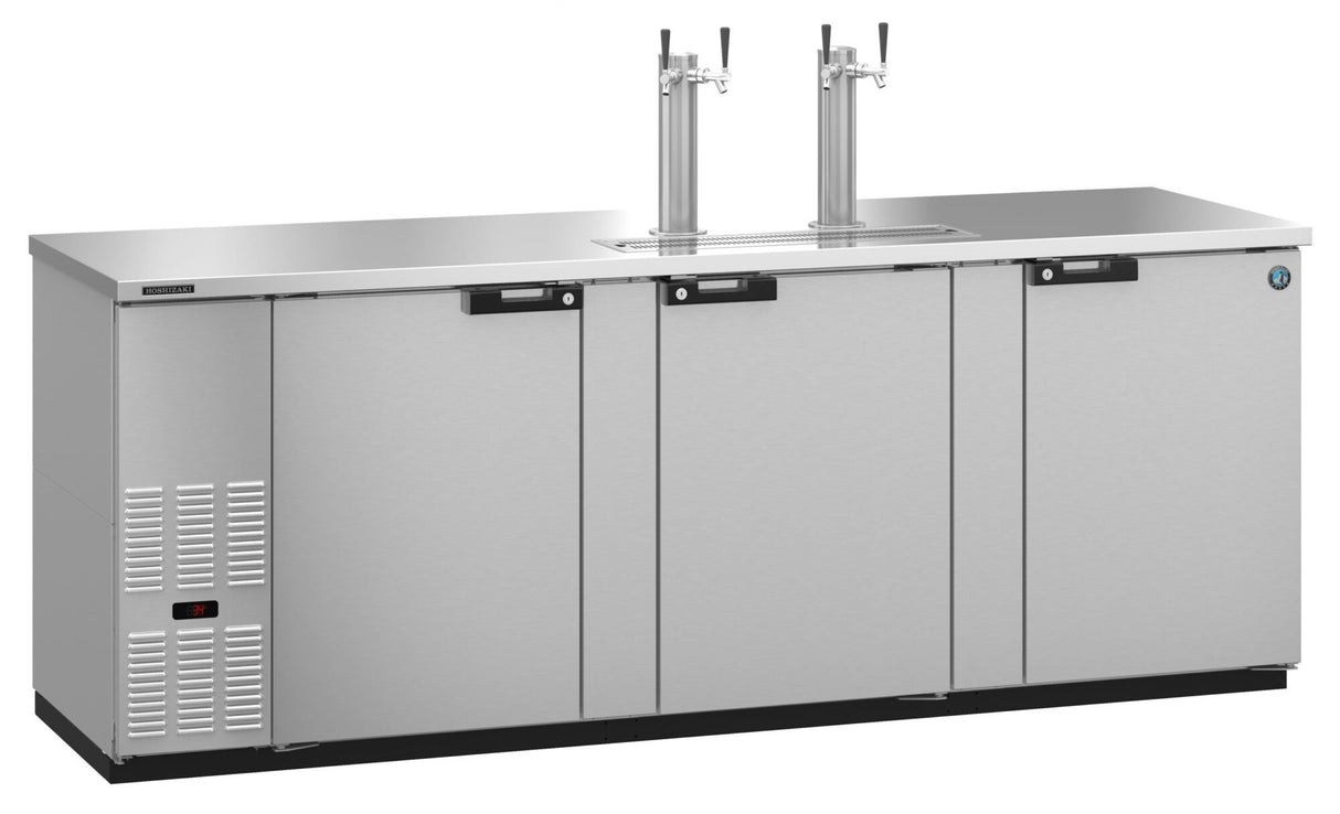 A stainless steel Draft Beer Cooler featuring three-section doors, self-contained refrigeration, two beer taps on top, ventilation slats on the left, black handles, and a digital display near the bottom left. The surface is flat and smooth.