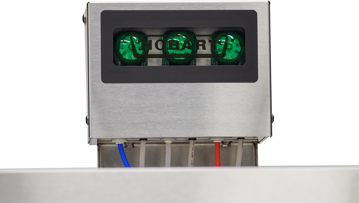 A close-up of a stainless steel HOBART commercial dishwasher shows three green indicator lights. Below, clear blue, red, and white tubes hint at chemical sanitizing, emphasizing its role as a robust industrial appliance.