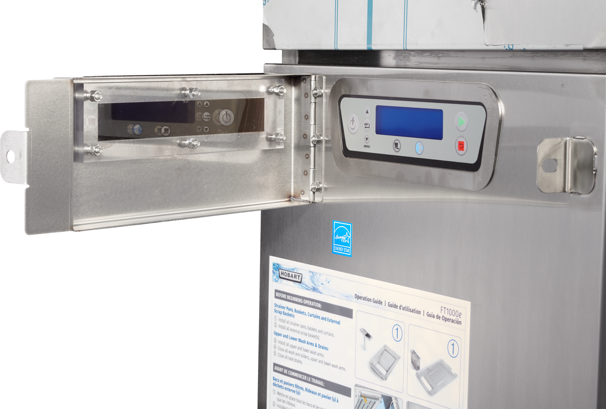 A close-up of a stainless steel Hobart FT1000E flight type dish machine with a control panel featuring digital displays, buttons, and an open protective metal cover. Instructional stickers are visible on the front. The background is white.
