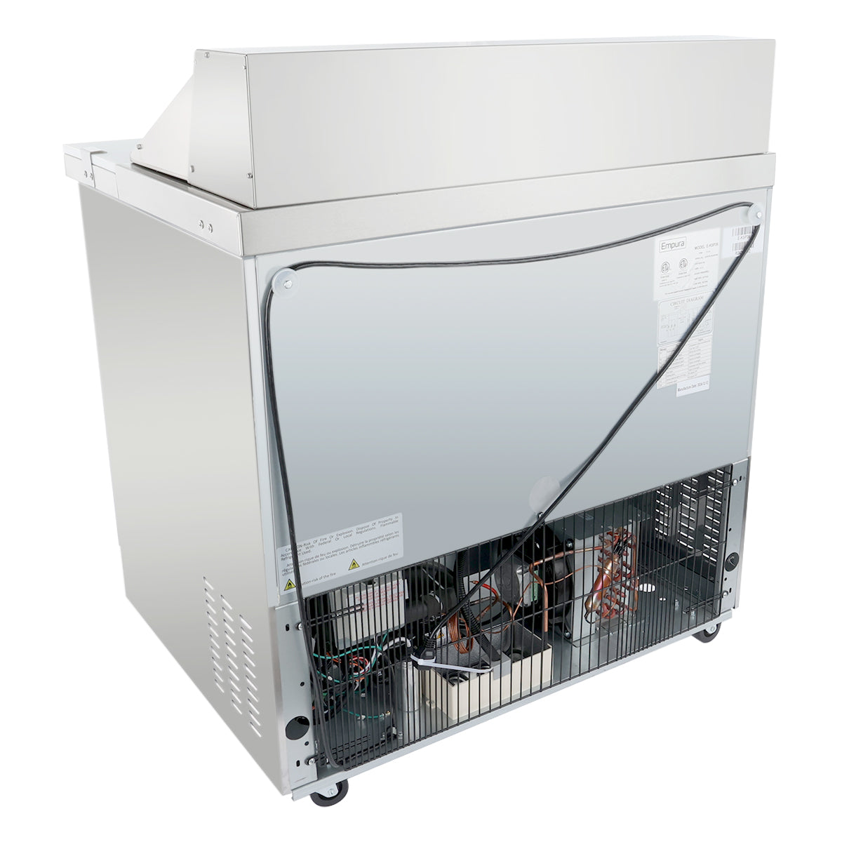 A stainless steel Empura refrigeration salad prep table is shown from the back. Its lower panel is open, revealing wiring, a black compressor, and metal grates. The refrigerated sandwich prep table rests on small wheels for easy mobility.