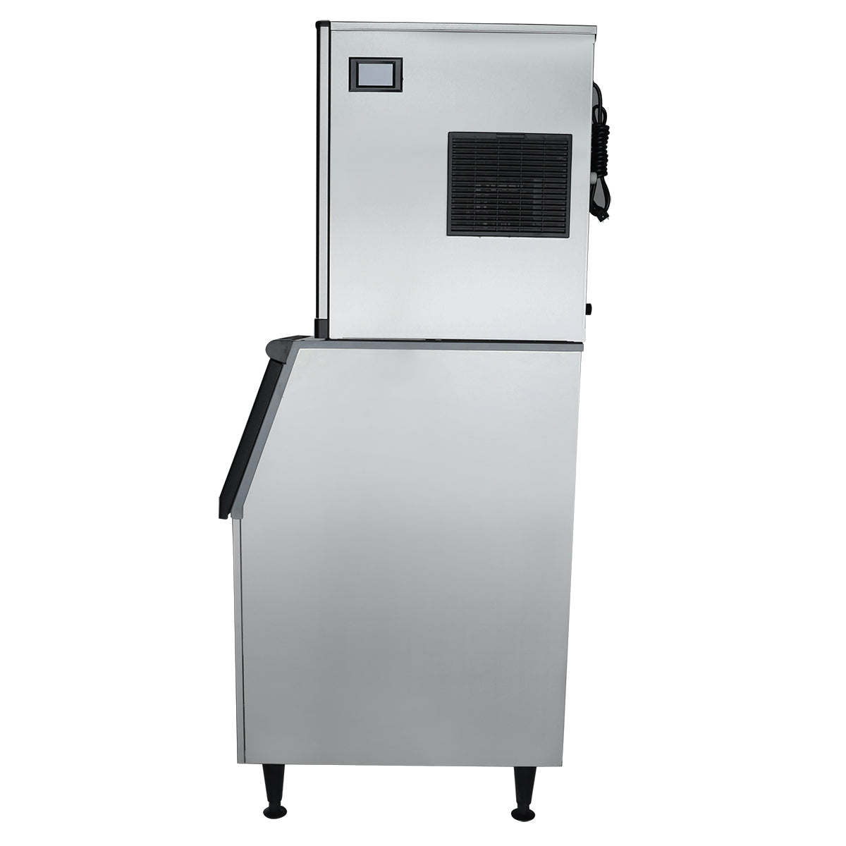 A full cube ice maker is shown from the side against a white background. The stainless steel machine features a rectangular upper unit, front vent, small digital display, and black trim. It stands on four black legs with a wider, angled commercial ice bin below.