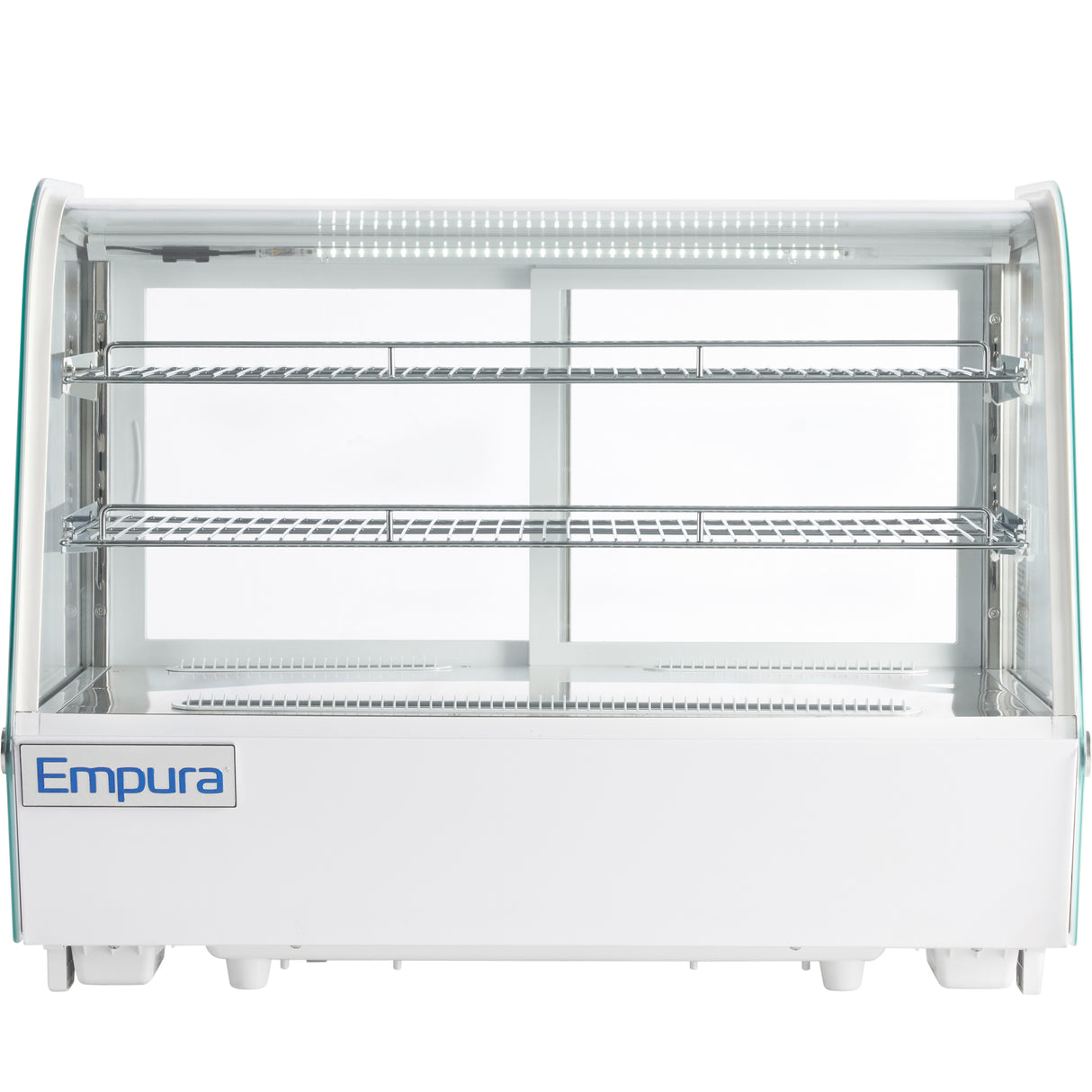A white Empura refrigerated display case sits on the counter, featuring two glass shelves, clear curved glass front, and interior LED lighting. This countertop display case is empty, with a blue Empura logo on the bottom left corner.