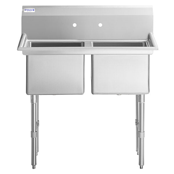 A stainless steel, 2 compartment commercial kitchen sink with a high backsplash and two pre-drilled faucet holes. It features sturdy tubular legs with adjustable feet and deep rectangular basins, ideal for kitchen or industrial use.