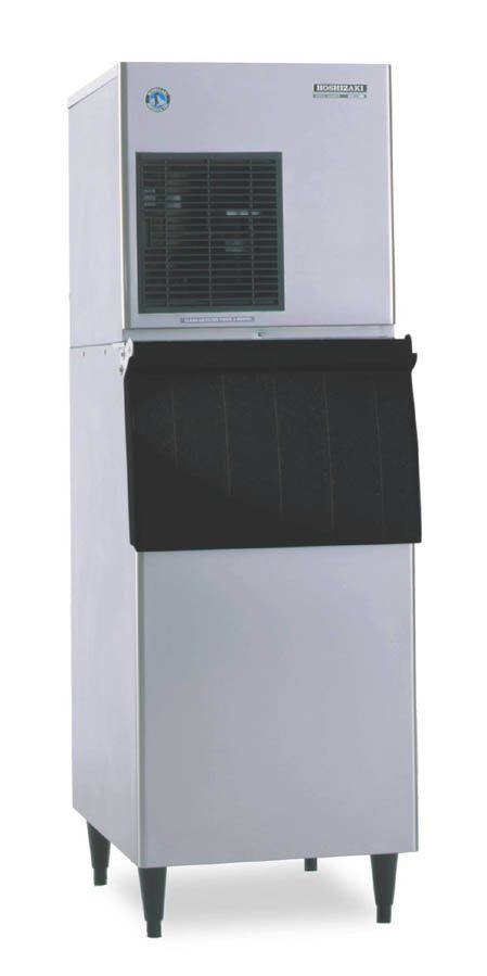 A commercial stainless steel Hoshizaki F-450MAJ flake ice maker with a vented panel near the top and a large black front bin for ice collection. This air-cooled ice machine stands on four short legs and is perfect for commercial or industrial settings.