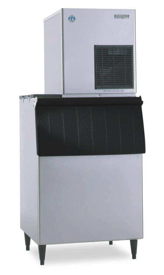 A commercial ice machine with a large stainless steel body, black vented panel on the upper front, and a black pull-down door below. This air-cooled ice maker stands on four legs and features a boxy, utilitarian design for industrial or food service use.