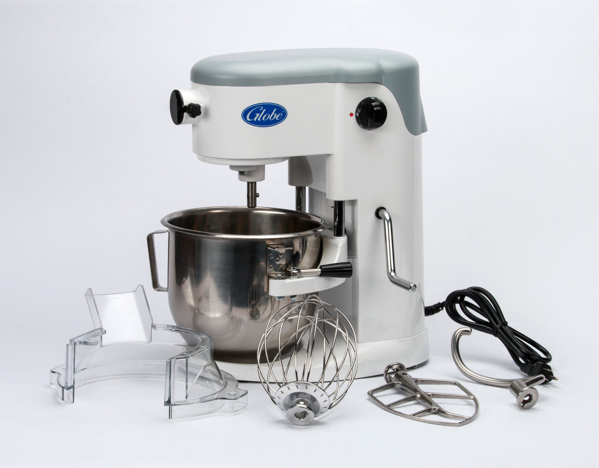 A white 5 qt mixer with a metal mixing bowl, three attachments (whisk, beater, dough hook), clear splash guard, and black power cord. This countertop mixer features a “Globe” label and silver handle, all displayed on a white background.
