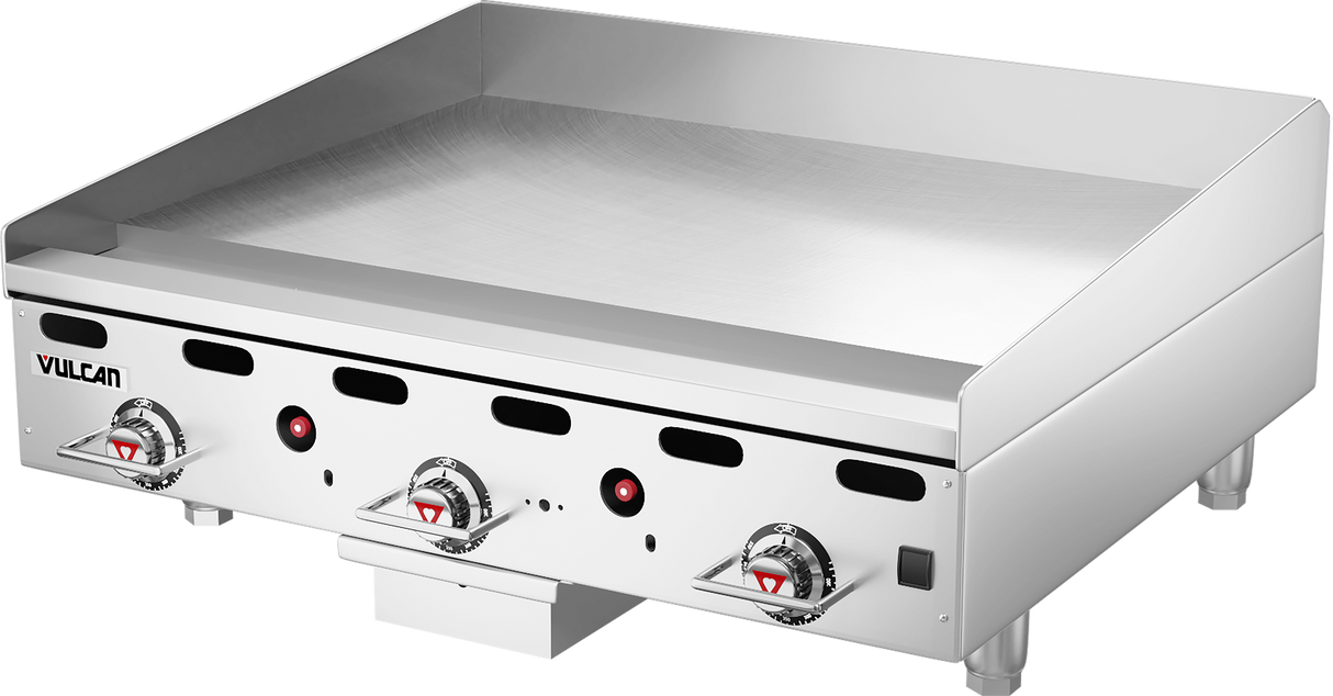 A stainless steel Vulcan 36 inch heavy duty griddle with a smooth flat cooking surface, three control knobs, red indicator lights, and short metal legs. This countertop gas griddle features a raised backsplash and sleek, modern appearance for restaurant kitchens.